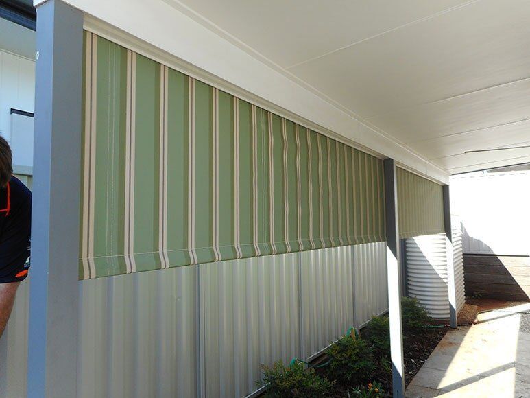 Green and White Striped Awning Covers Corrugated Wall Under a White Roof — Toowoomba Shade & Canvas in Harristown, QLD