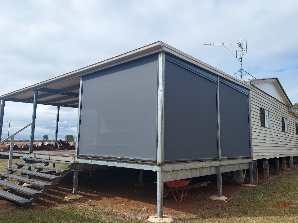 Grey Roller Blinds on a Porch of a Weathered House — Toowoomba Shade & Canvas in Harristown, QLD