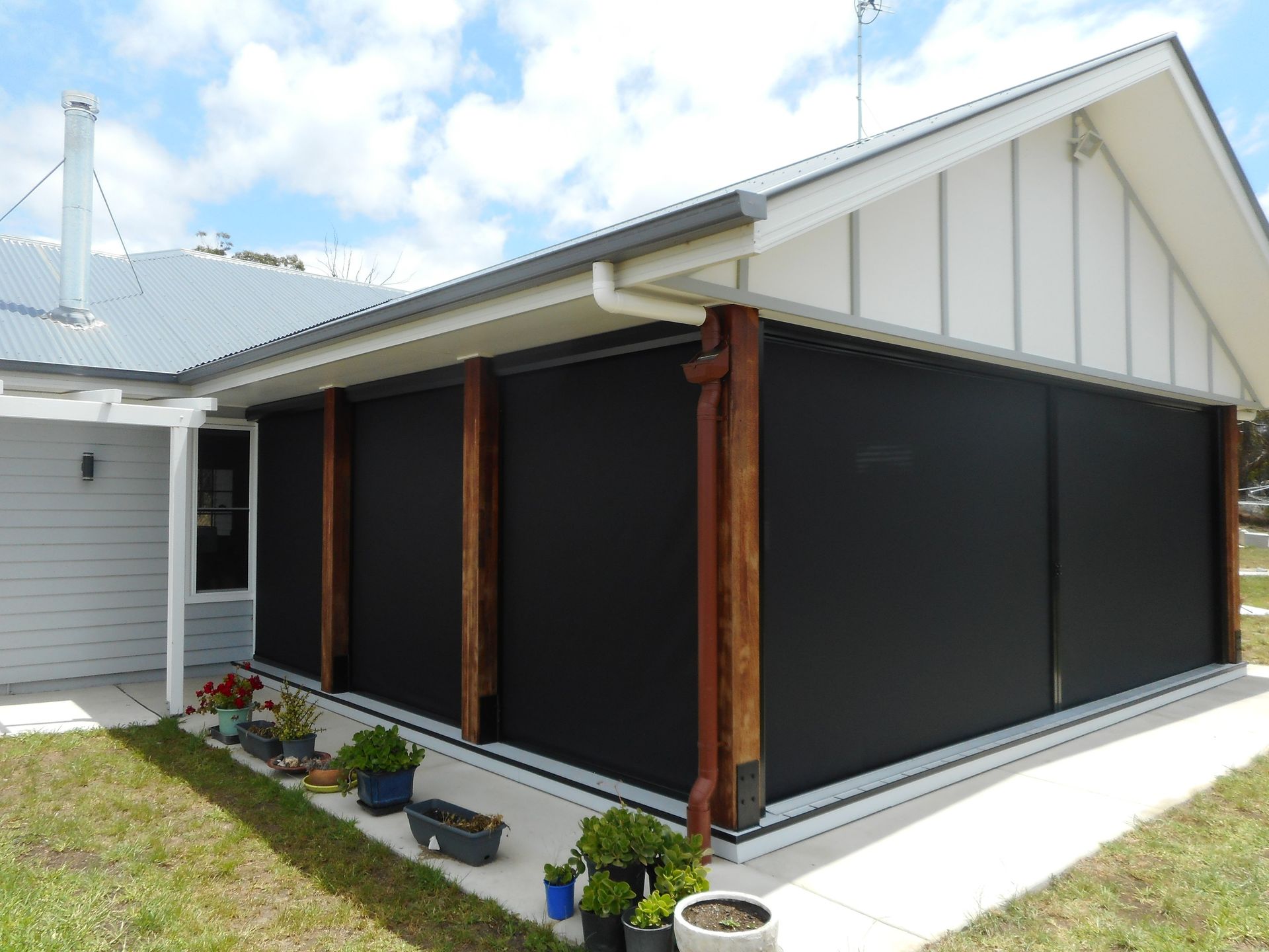 Exterior of a House With Dark Black Sun Shades on a Porch — Toowoomba Shade & Canvas in Harristown, QLD