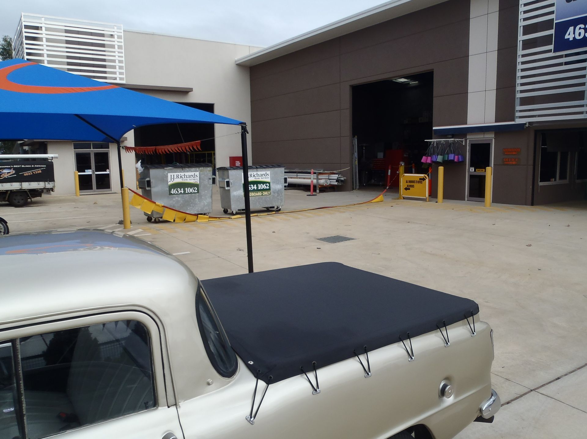Silver Vintage Pickup Truck With Black Cover in a Paved Lot — Toowoomba Shade & Canvas in Harristown, QLD