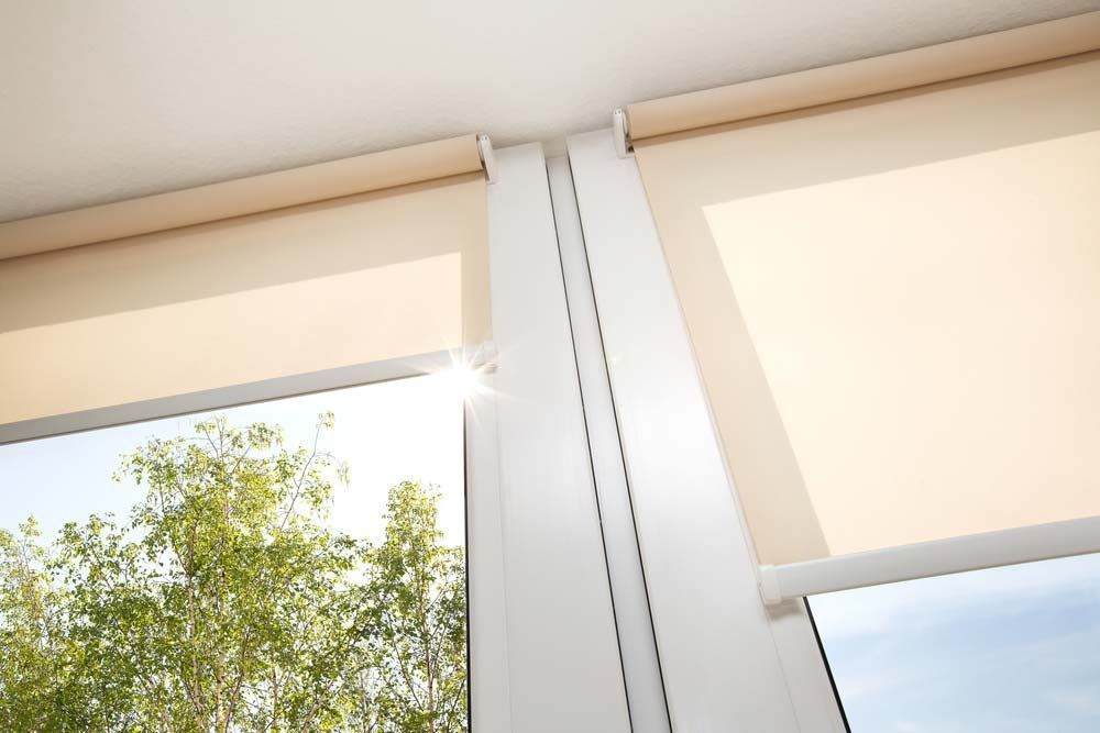Beige Roller Shades Partially Covering Windows — Toowoomba Shade & Canvas in Harristown, QLD