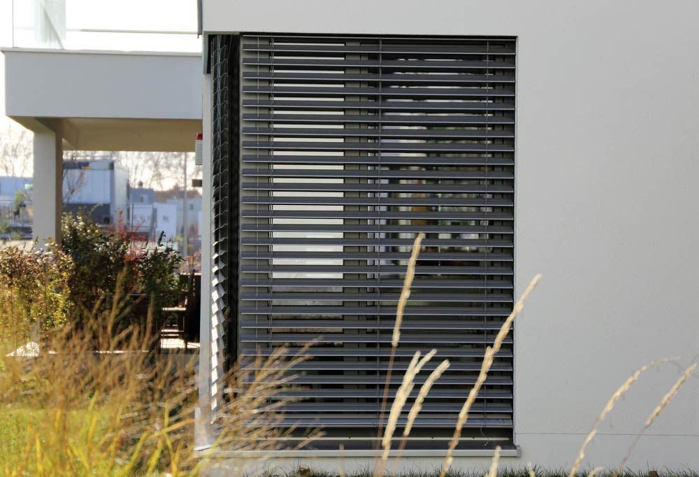 Modern Building With Dark Gray Blinds on a Window — Toowoomba Shade & Canvas in Harristown, QLD