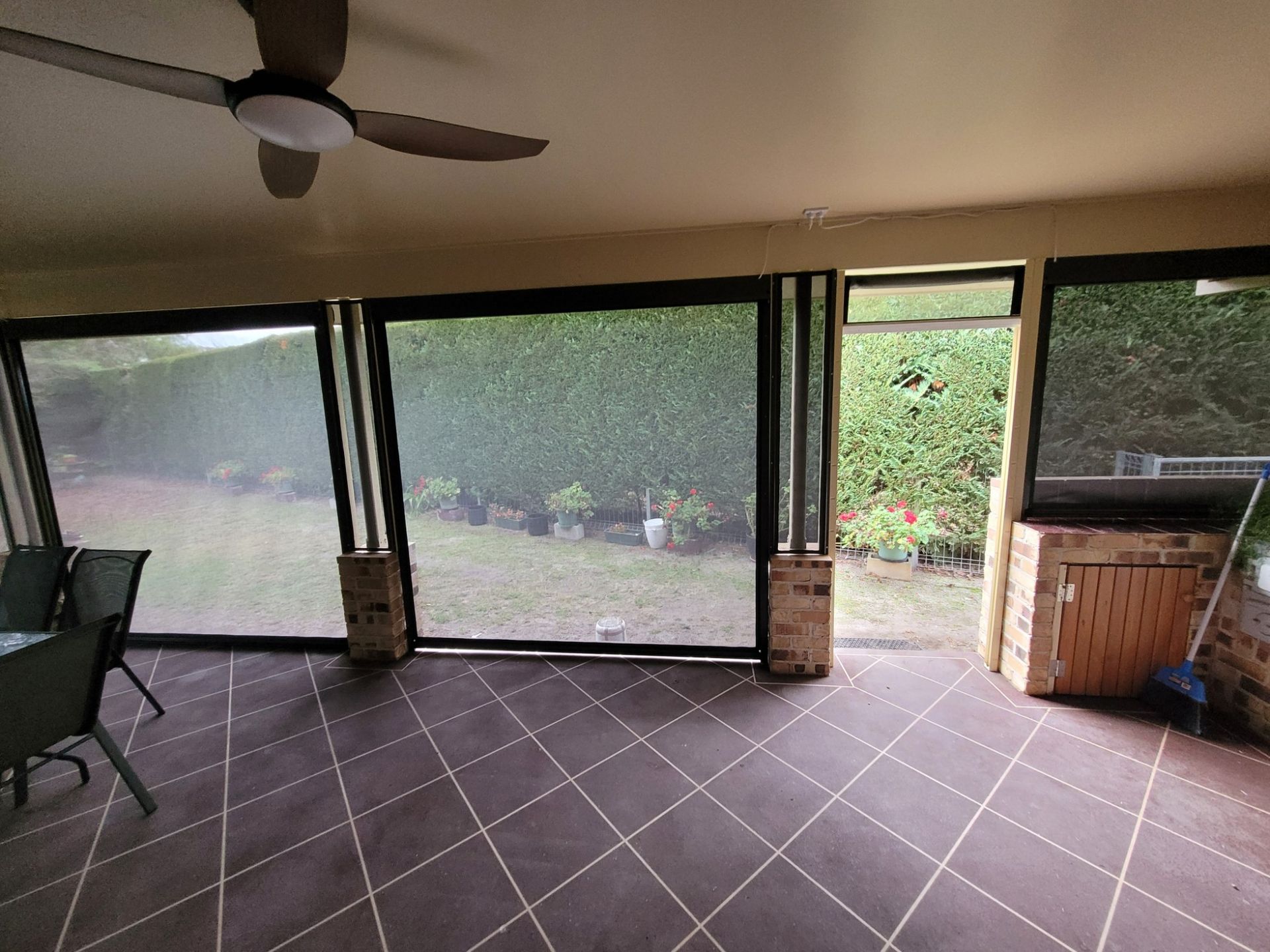 Patio With Closed Mesh Screens Overlooking a Backyard — Toowoomba Shade & Canvas in Harristown, QLD
