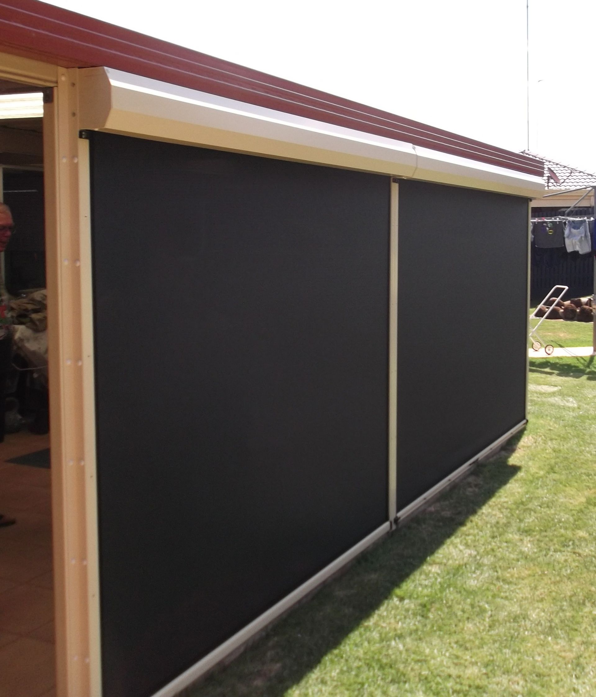 Black Outdoor Roller Shades Installed on a Patio — Toowoomba Shade & Canvas in Harristown, QLD