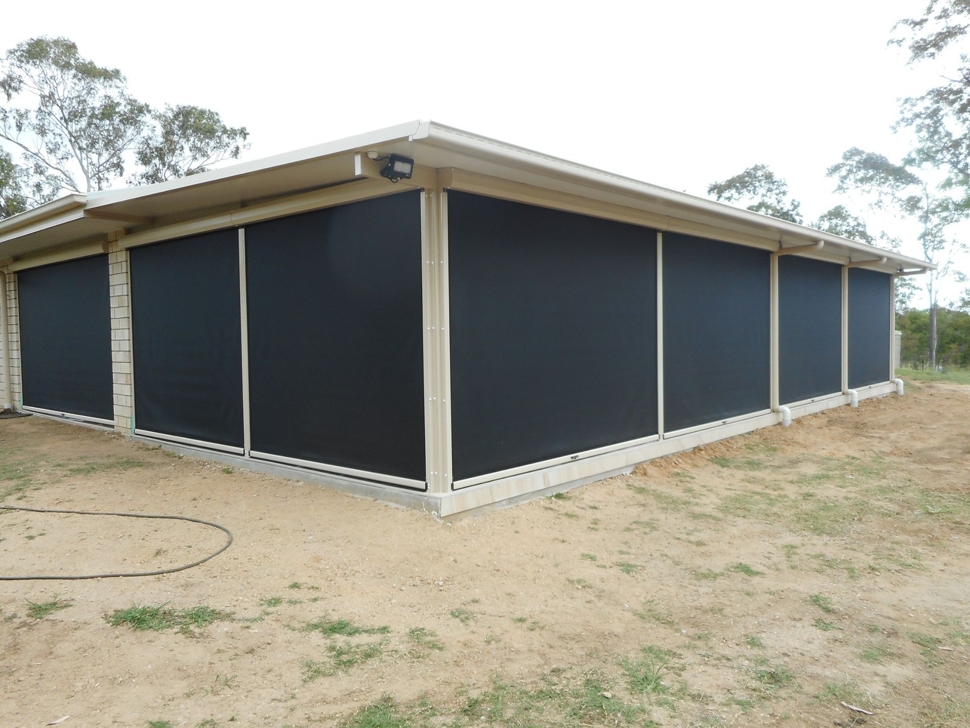 Black Sunshades on a Beige Building Exterior — Toowoomba Shade & Canvas in Harristown, QLD