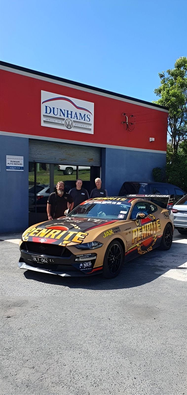 A Man Is Fixing A Car Battery With A Screwdriver — Dunhams Auto Repairs In Woonona, NSW