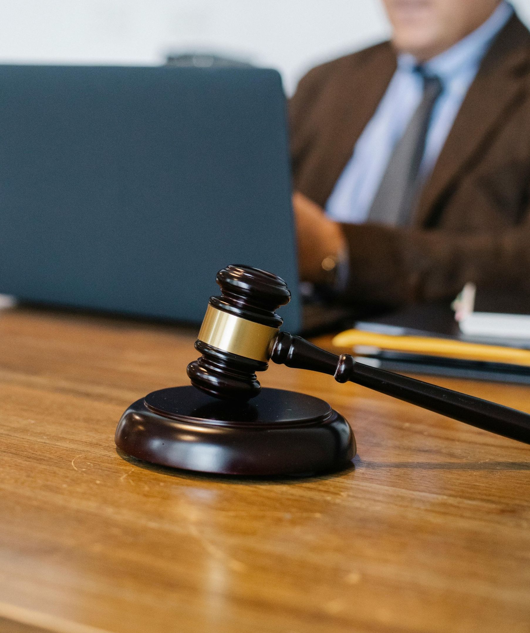 A microphone is sitting on a wooden table in a courtroom.