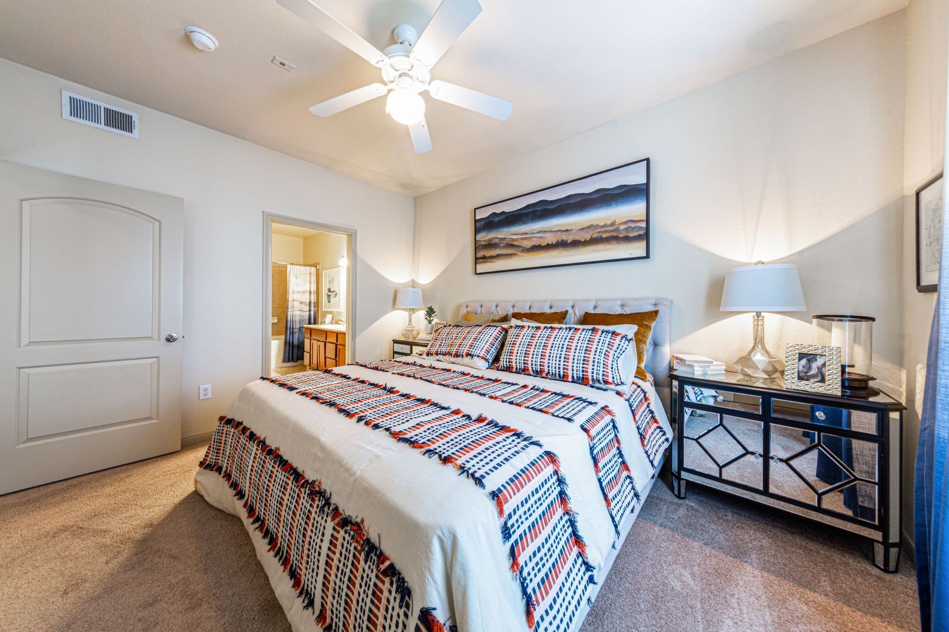A bedroom with a king-size bed and a ceiling fan at Marquis Grand Lakes in Richmond, TX.