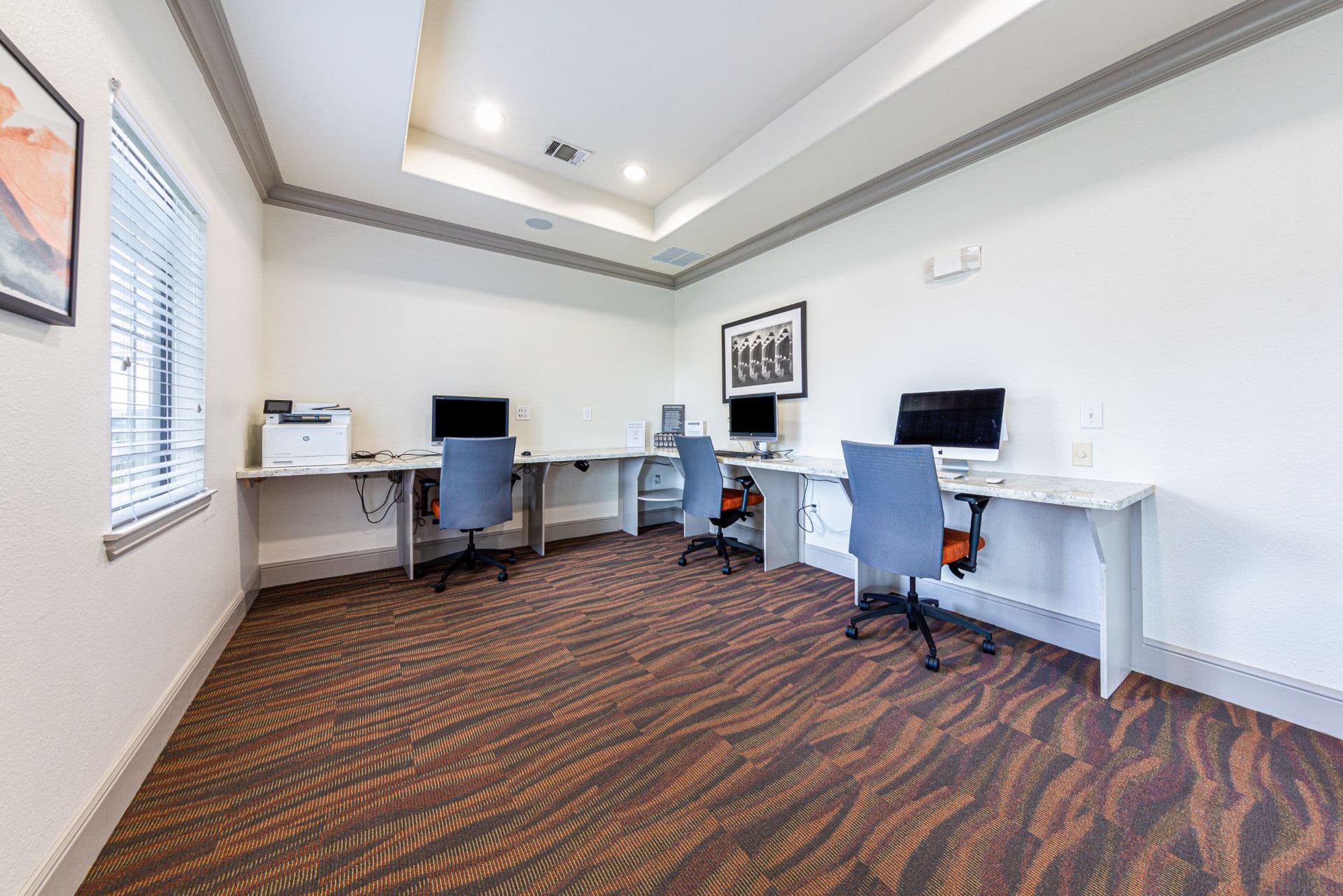 A room with a lot of desks and chairs and computers at Marquis Grand Lakes in Richmond, TX.