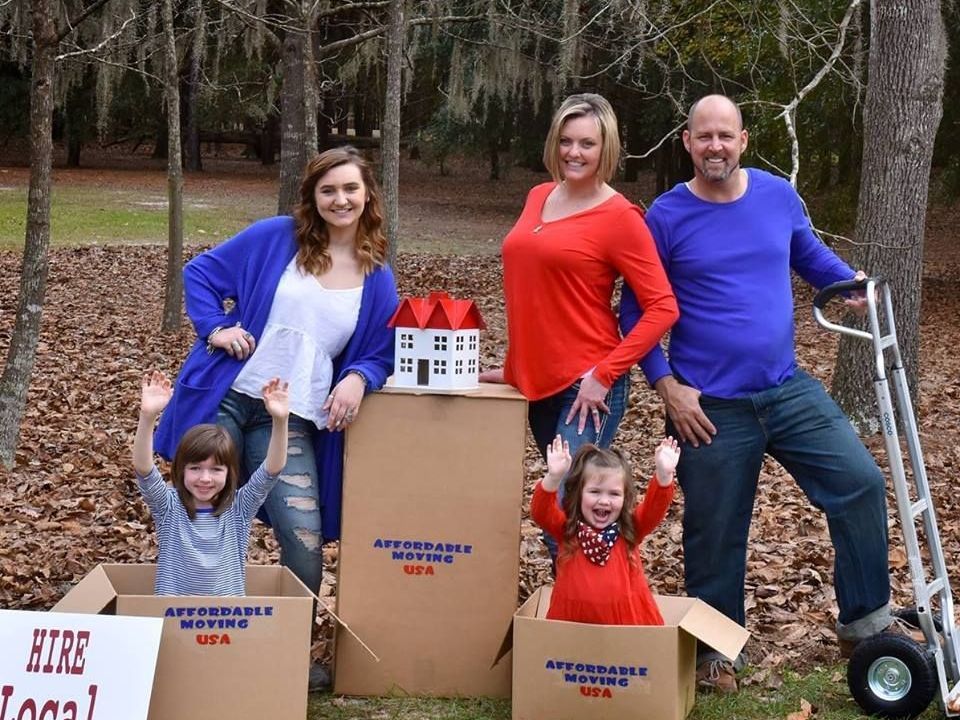 Furniture, belongings and moving boxes in room