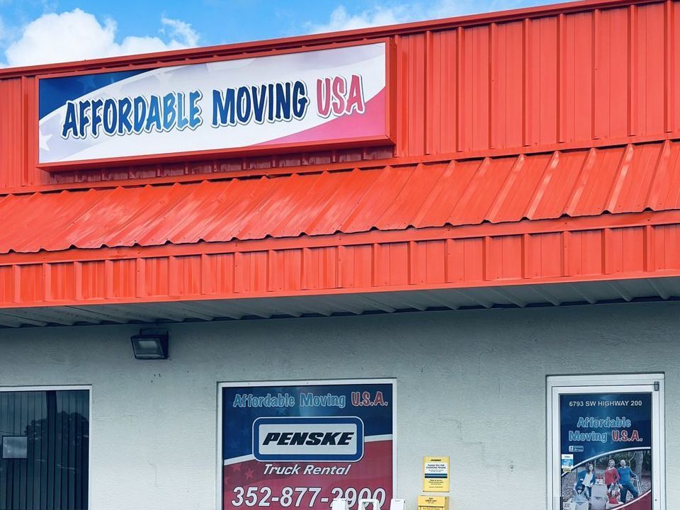 Male movers wrapping sofa with stretch film in room, closeup