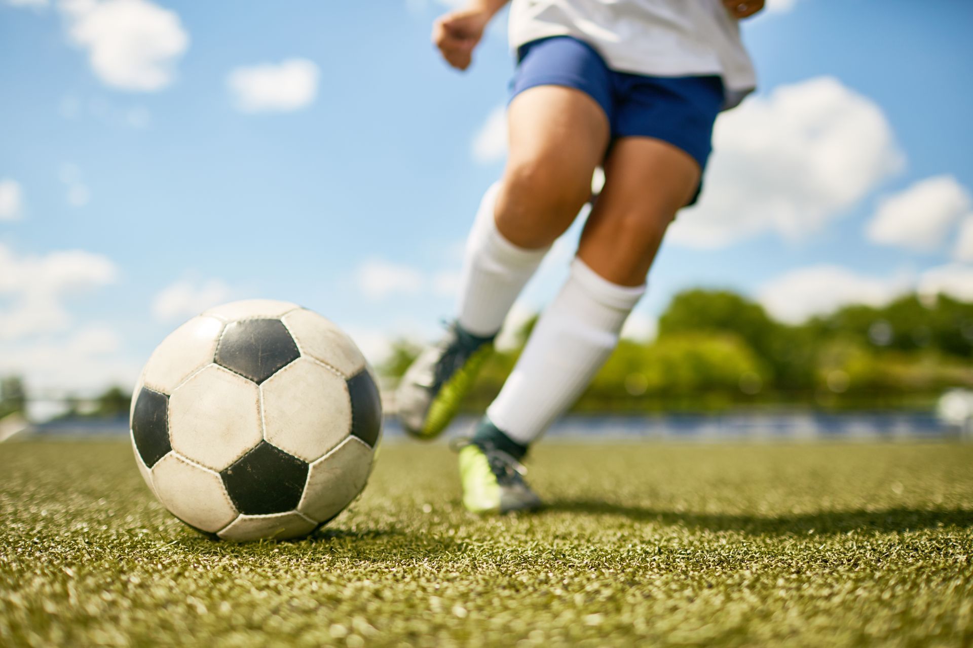 Soccer player kicking a soccer ball