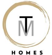 a logo for homes with a letter m in a circle .