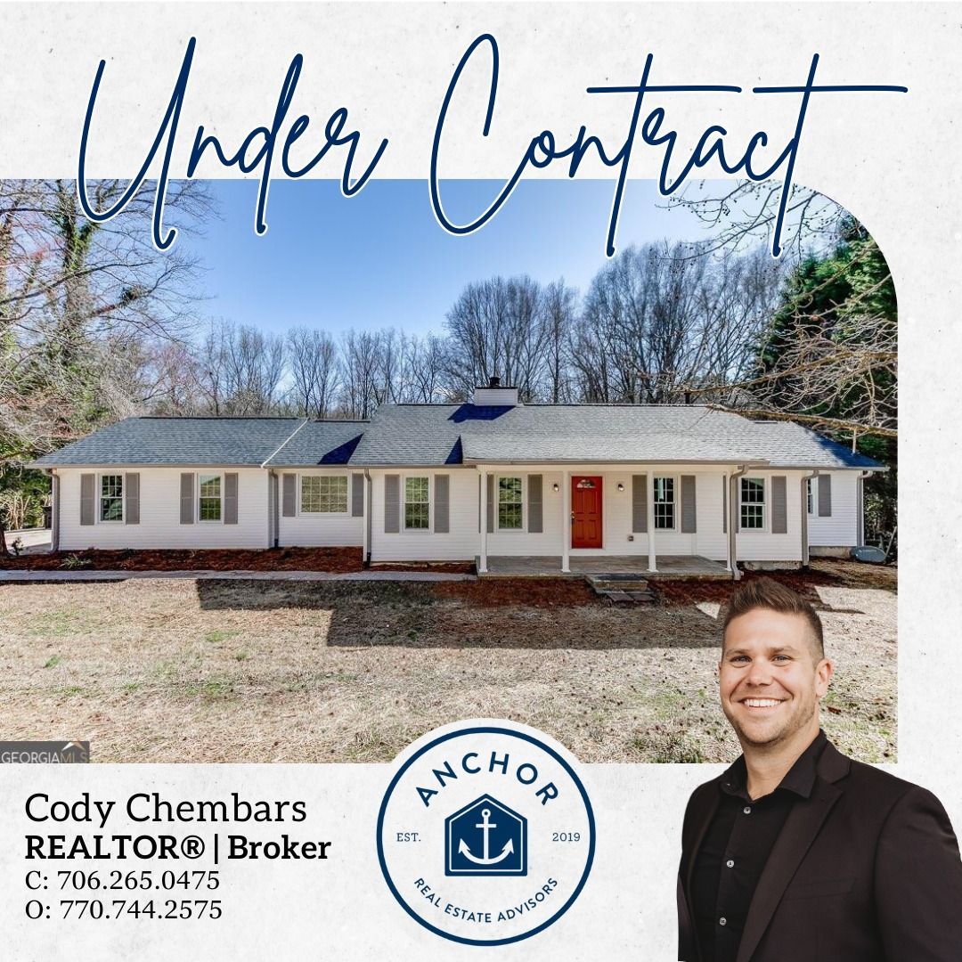 A man is standing in front of a house that is under contract