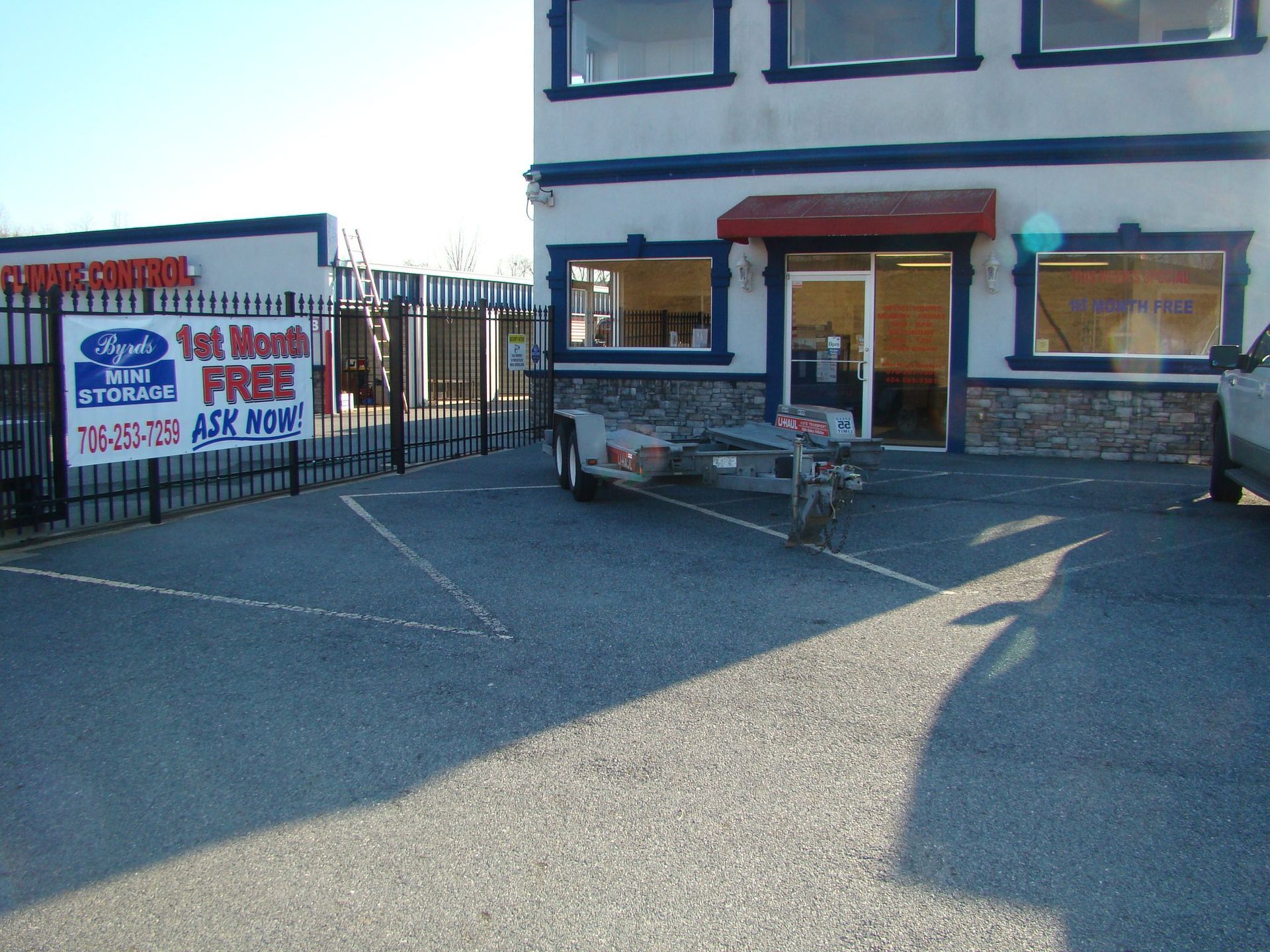 A trailer is parked in front of a building that says free for a month