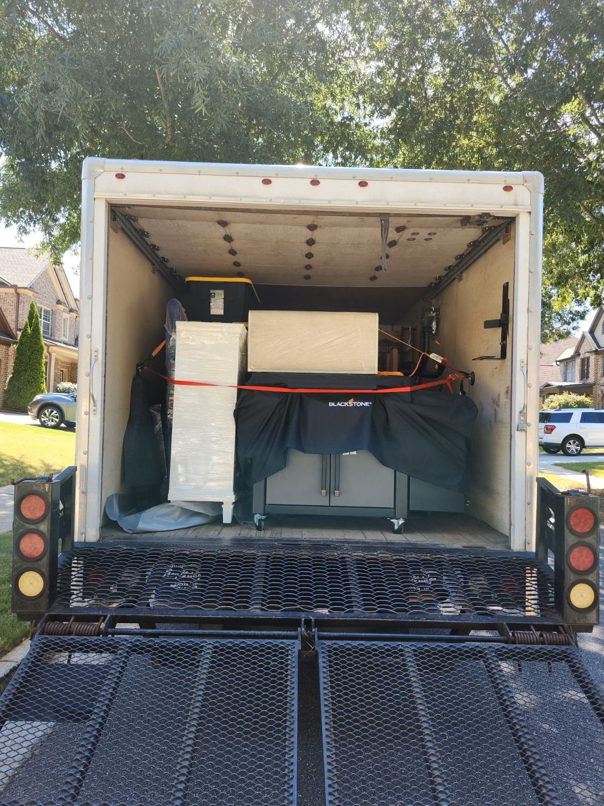 The back of a moving truck with the door open