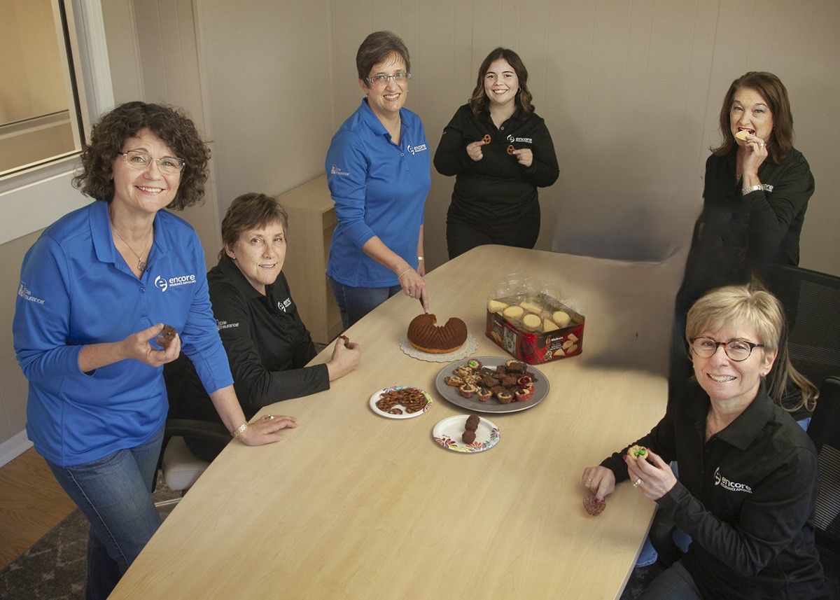 A group of business people are posing for a picture together