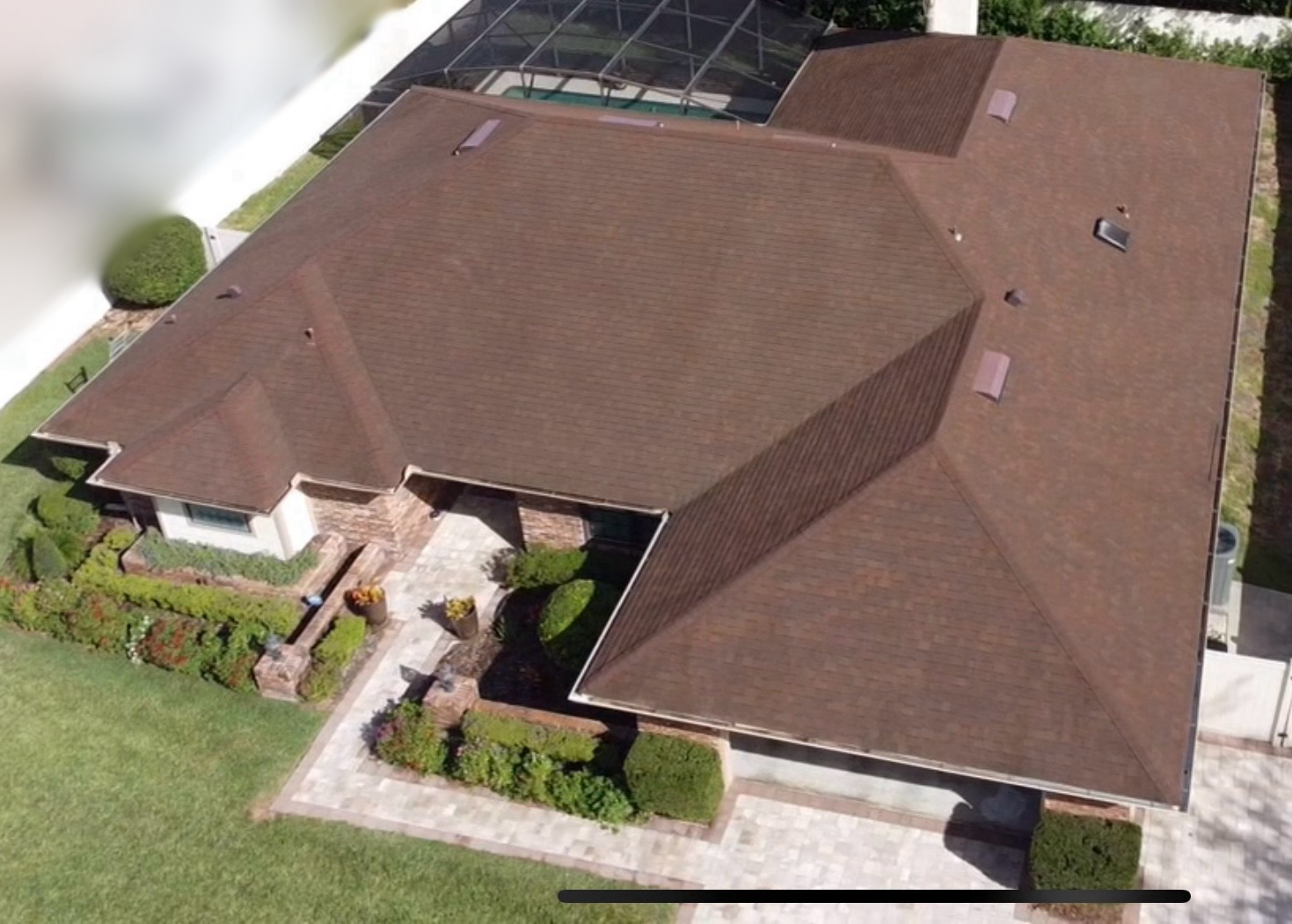 An aerial view of a house with a brown roof