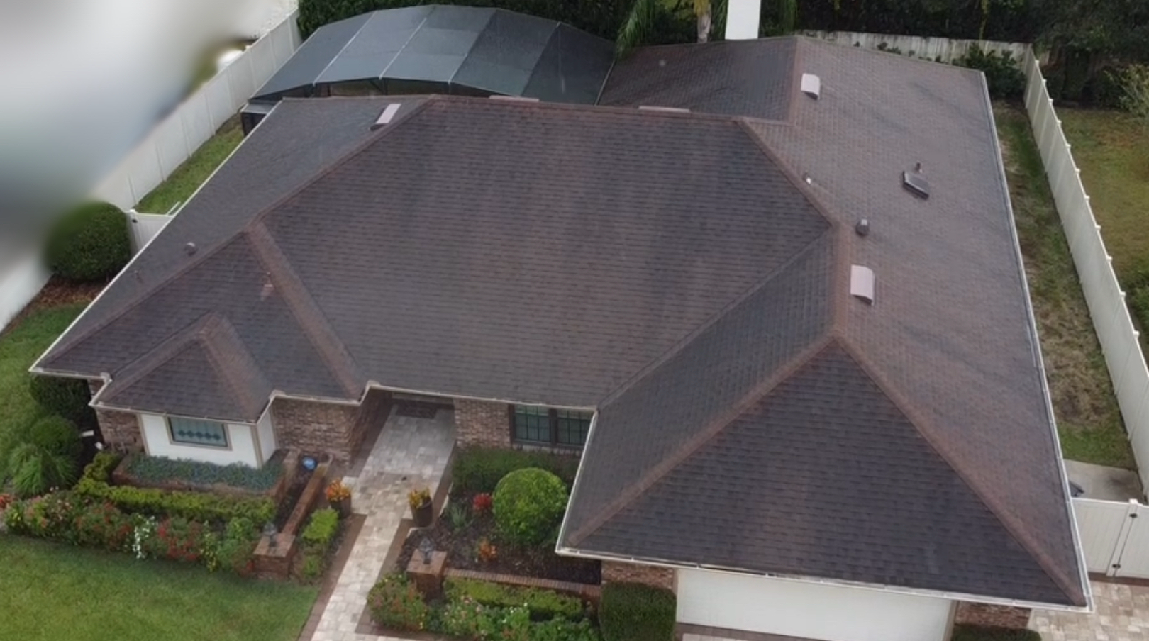 An aerial view of a house with a large roof.