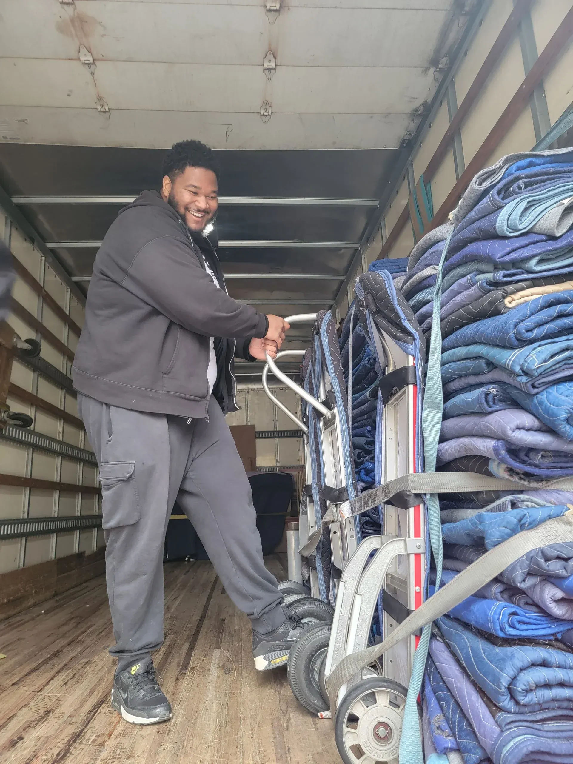 CJ Moving crew loading furniture from a large Durham NC home