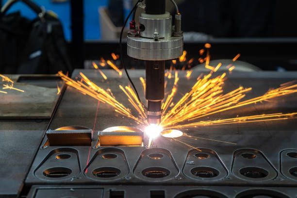 Fiber laser cutting machine cutting sheet metal with sparks, precision laser cutting technology.