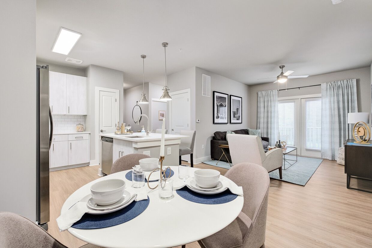 A dining room table with plates and bowls on it in a living room.