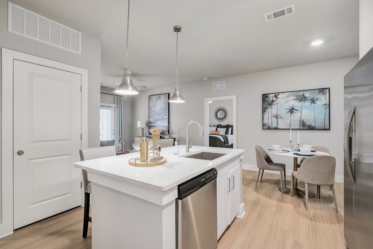 A kitchen with a large island and stainless steel appliances.