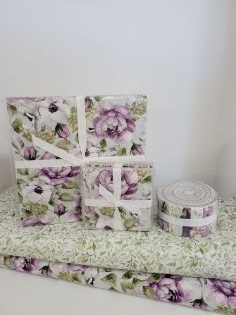 Textiles with purple and green flowers and a white bow from a local quilt shop. Textiles with purple and green flowers and a white bow from a local quilt shop.