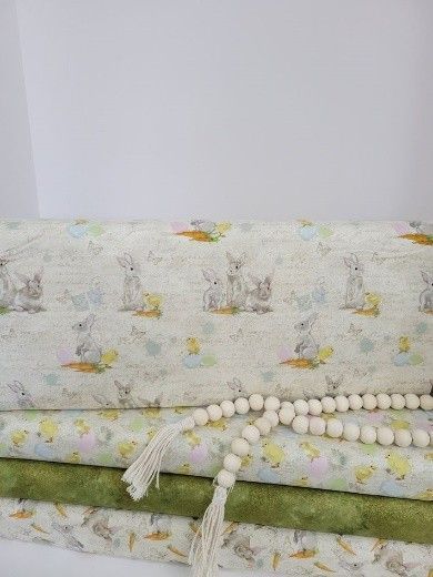 A white quilt with a bunnies texture, from a local quilt shop.