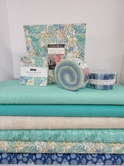 View of various quilts with aqua blue, from a local quilt shop.