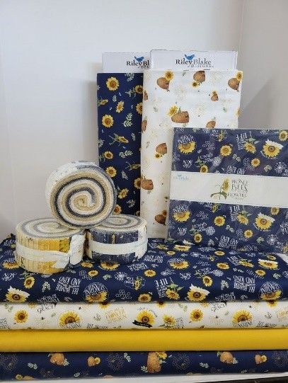 Dark blue and yellow quilts with sunflowers, from a local quilt shop.