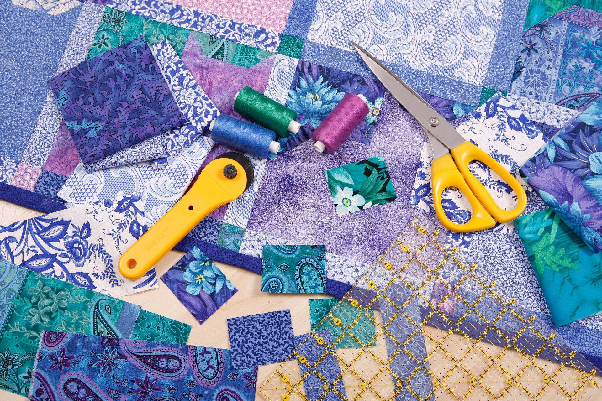Quilting tools on colorful fabric with scissors and thread. Quilting tools on colorful fabric with scissors and thread.