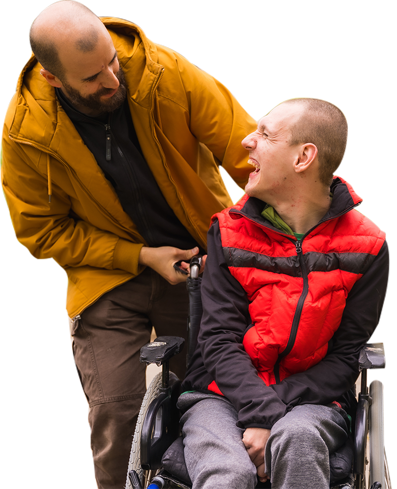 A man in a yellow jacket is standing next to a man in a wheelchair