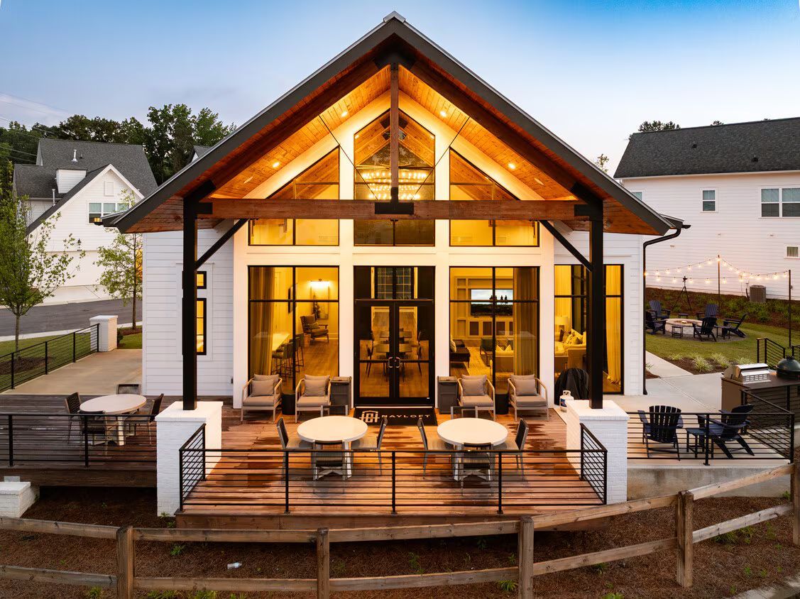 A living room with a lot of windows and furniture