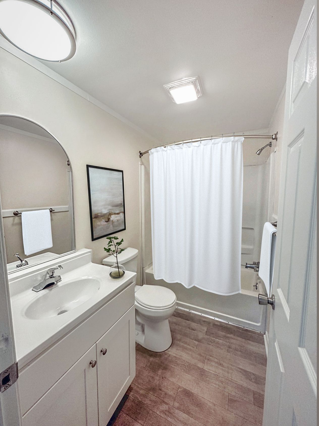 Photo of a bathroom with a bathtub and shower combination
