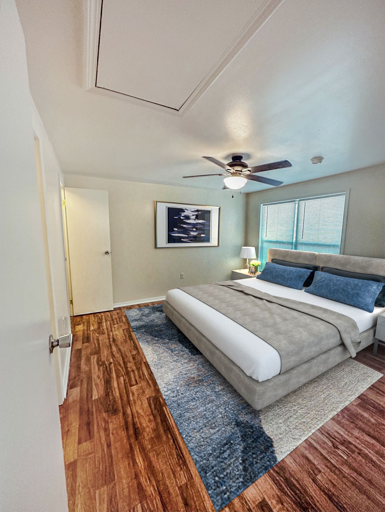 Photo of a large bedroom, showing the entrance to the room in the background