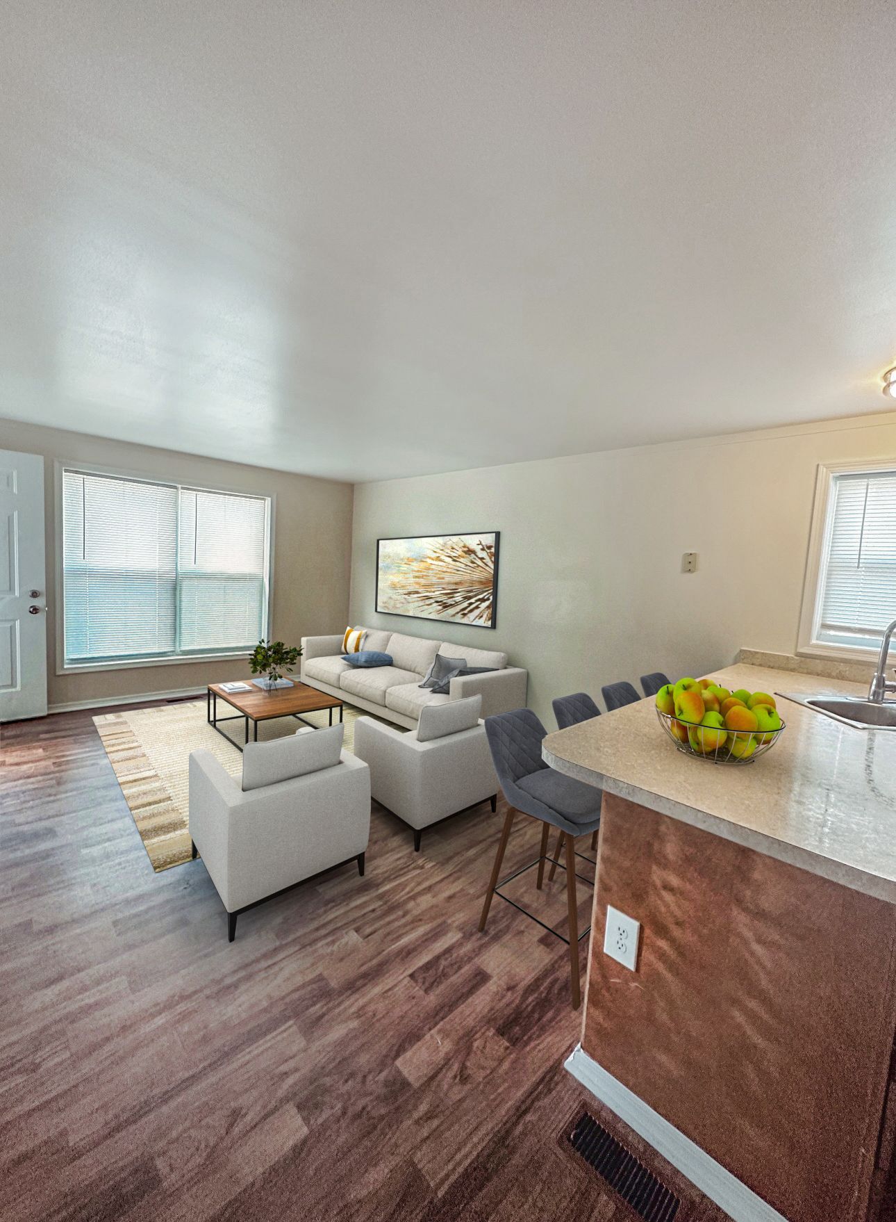 Photo of a living room, seen from the entrance to the kitchen, with plenty of natural lighting