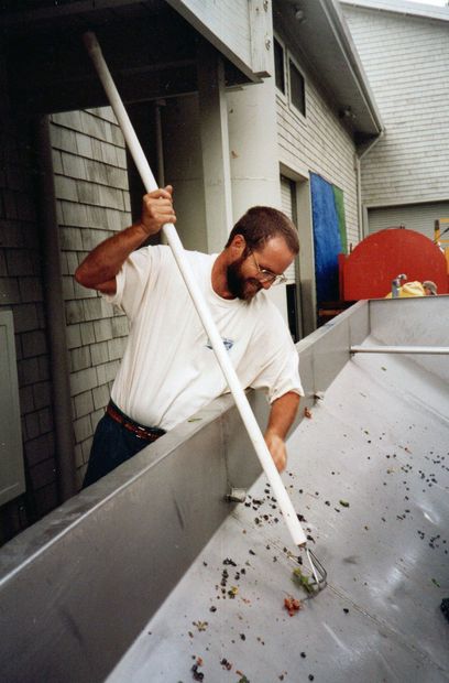 A man in a white shirt is holding a long white stick