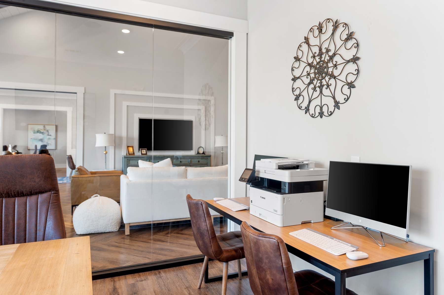 A home office with a desk , chairs , computer and printer  at Pointe Grand Spring Hill.