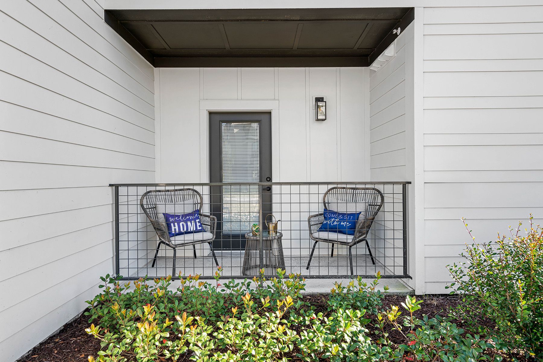 There is a balcony with two chairs and a table on it  at Pointe Grand Spring Hill.