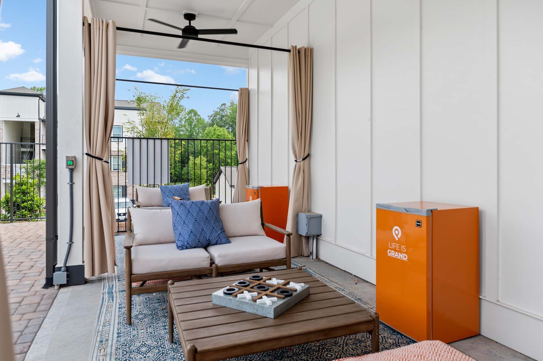 A living room with a couch , table , and a ceiling fan at Pointe Grand Spring Hill.