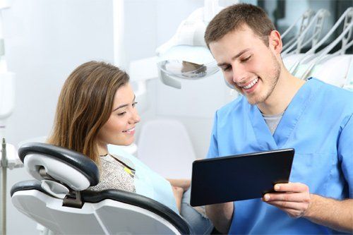 Dentist Talking To A Patient