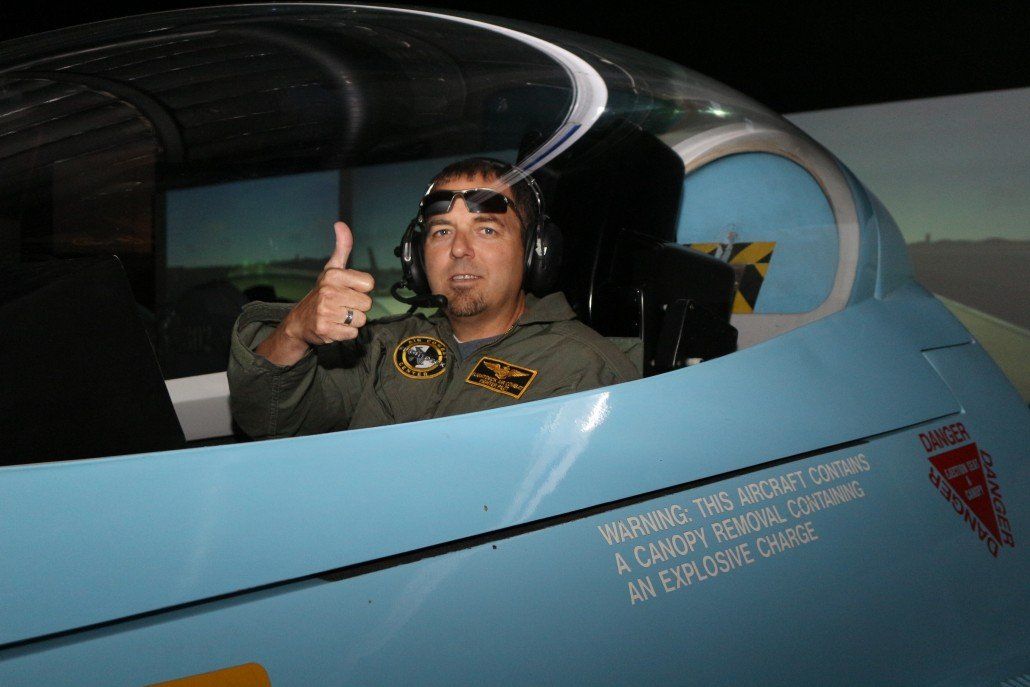 Customer in f-16 flight simulator giving thumbs up