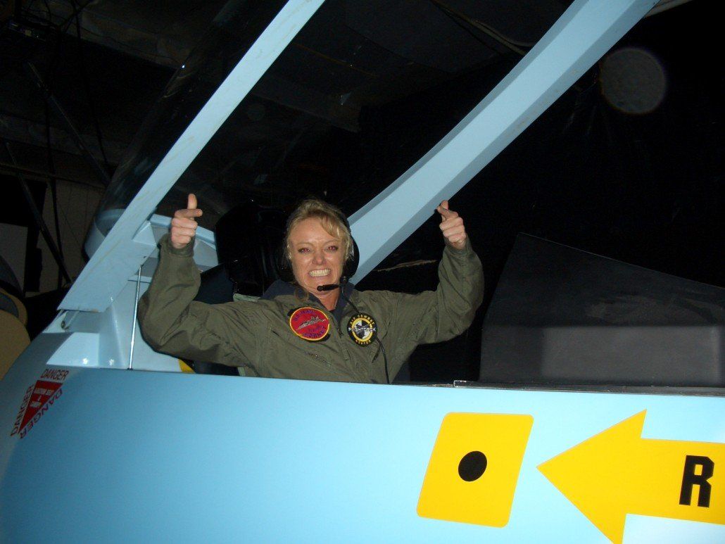 Excited woman in flight simuator