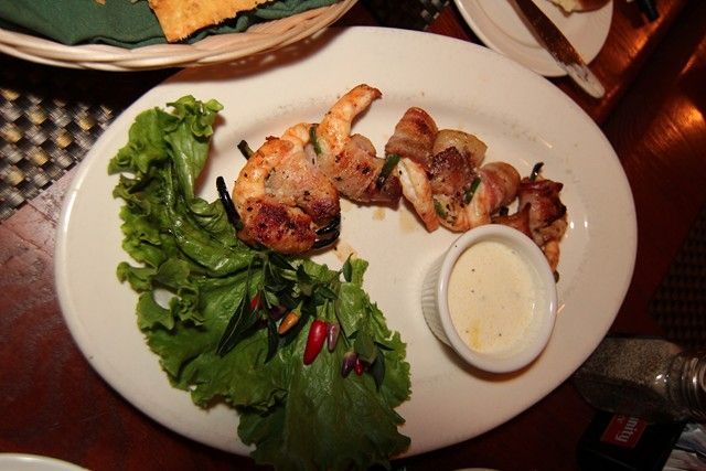 a plate of food with shrimp and lettuce on a table