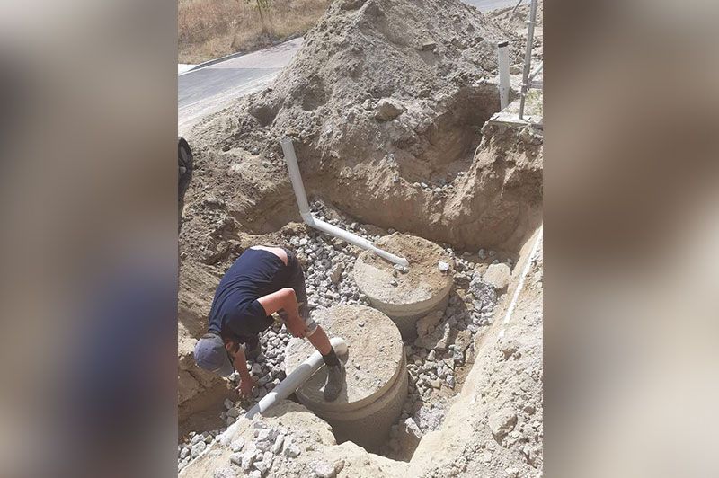 Man With A White Hat Handling Tubes For Drainage – Hamilton, NZ – Jamark Plumbing
