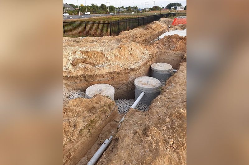White Pipe Going Through The Cement Cylinders – Hamilton, NZ – Jamark Plumbing
