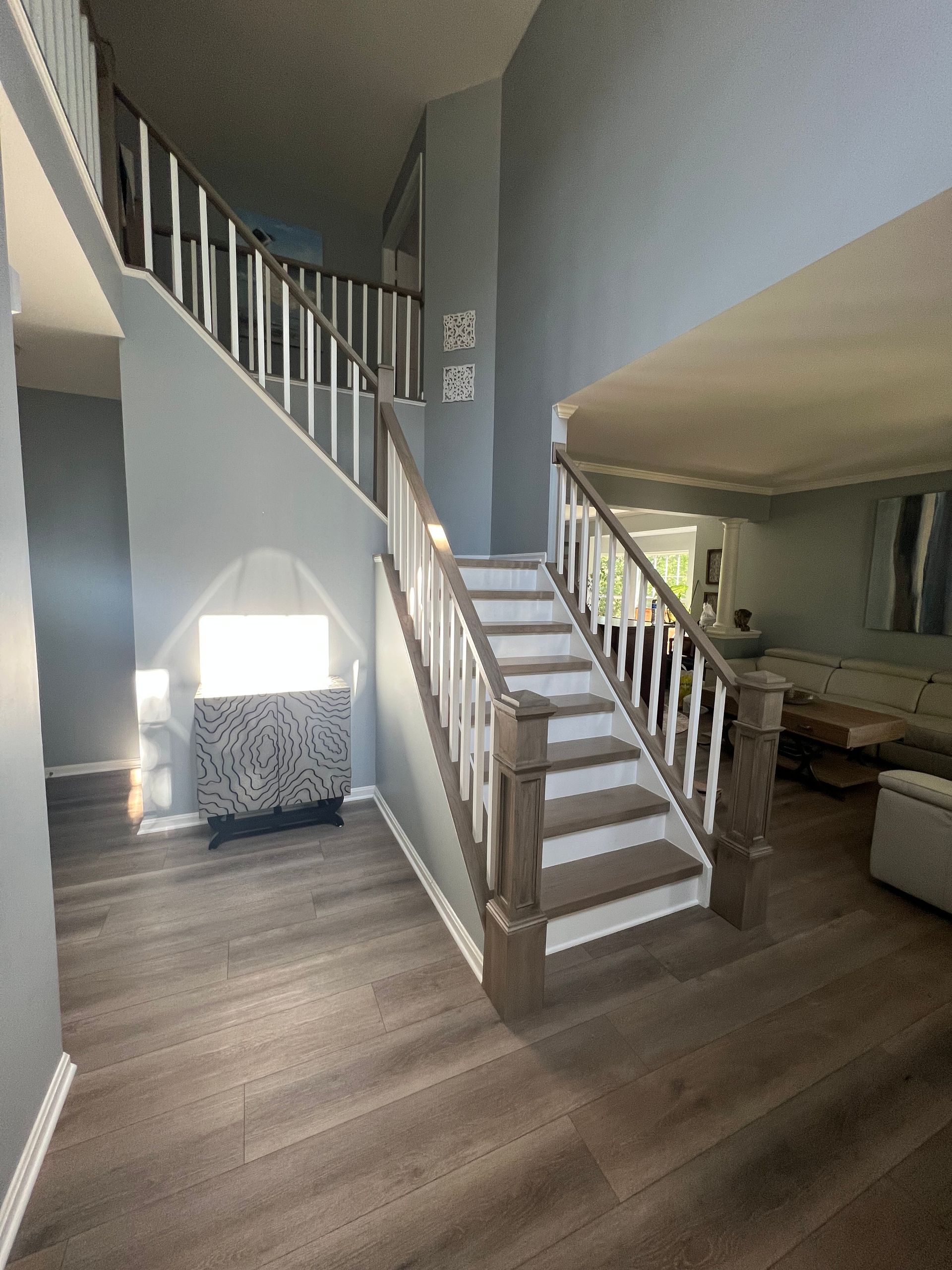 A living room with stairs leading up to the second floor