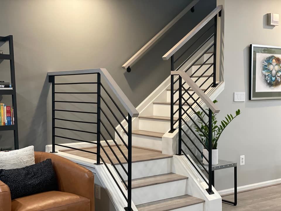 A living room with stairs leading up to the second floor