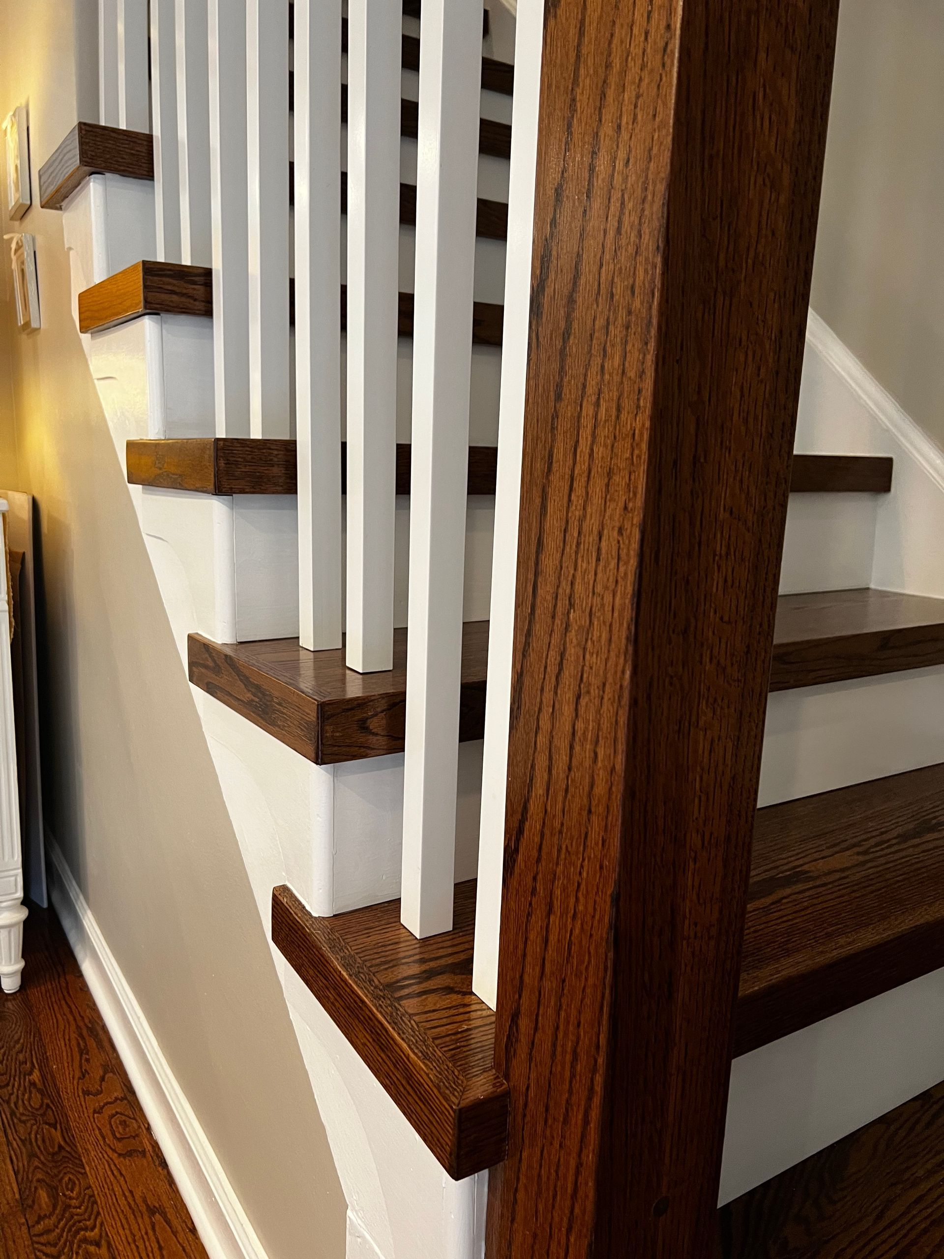 A staircase with wooden steps and white railing